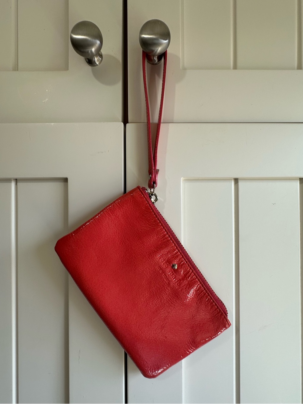 kate spade New York Harrison Street Bee wristlet in vibrant orange